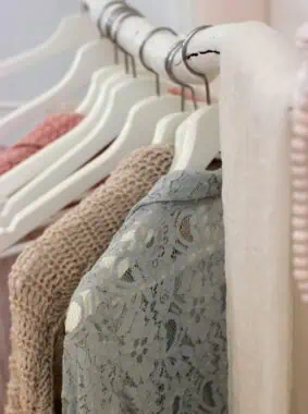 clothes hanging on white rack