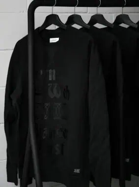 black sweatshirts on plastic hangers